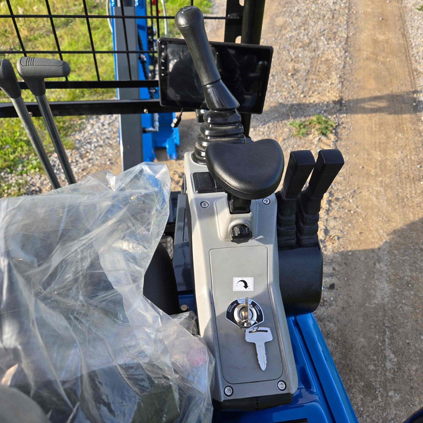 Ignition key and joystick control panel of Rippa R18 mini excavator inside operator cabin in Canada | Compact excavator JoyT5 for construction and landscaping work

