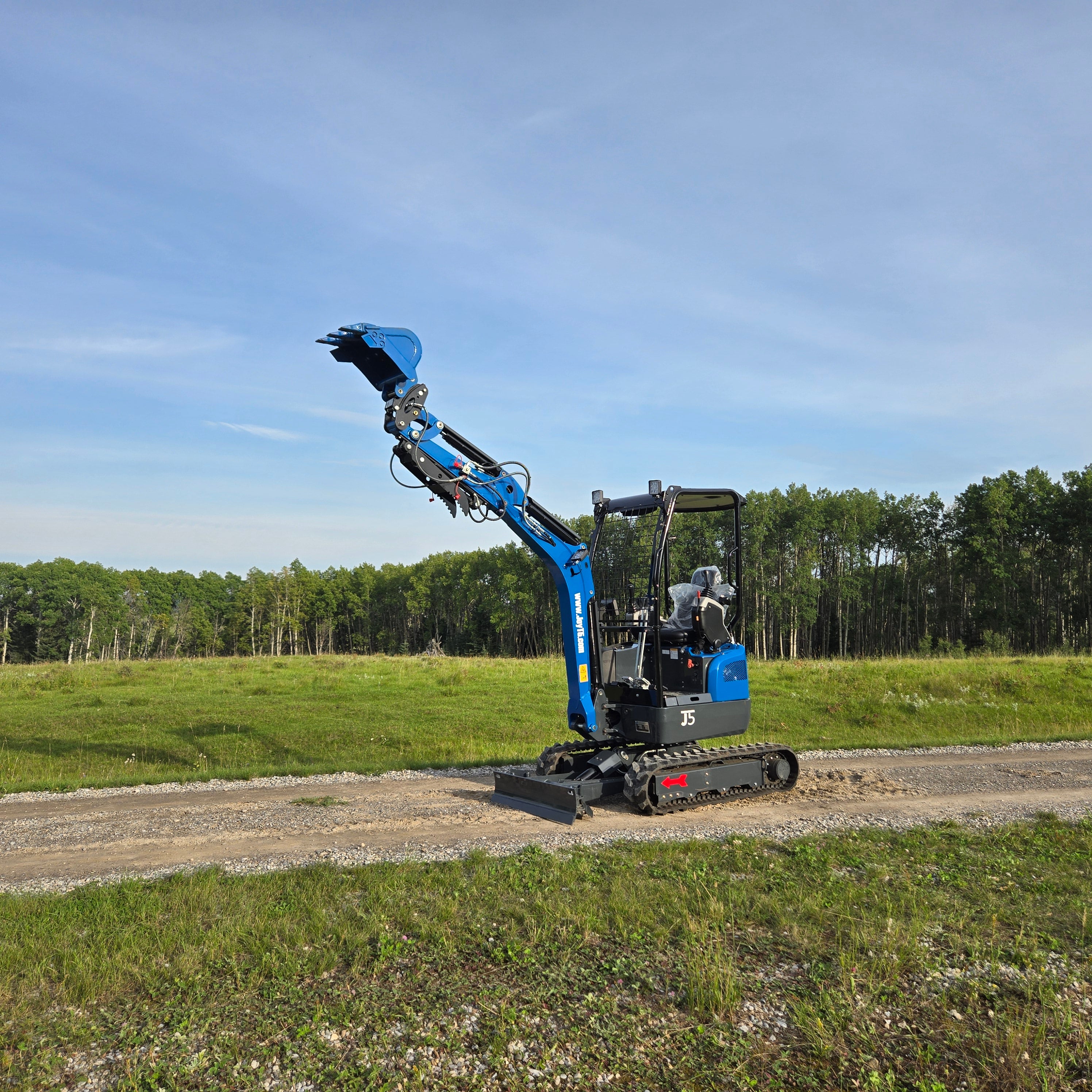Rippa R18- Mini Excavator with raised digging arm on a construction site.