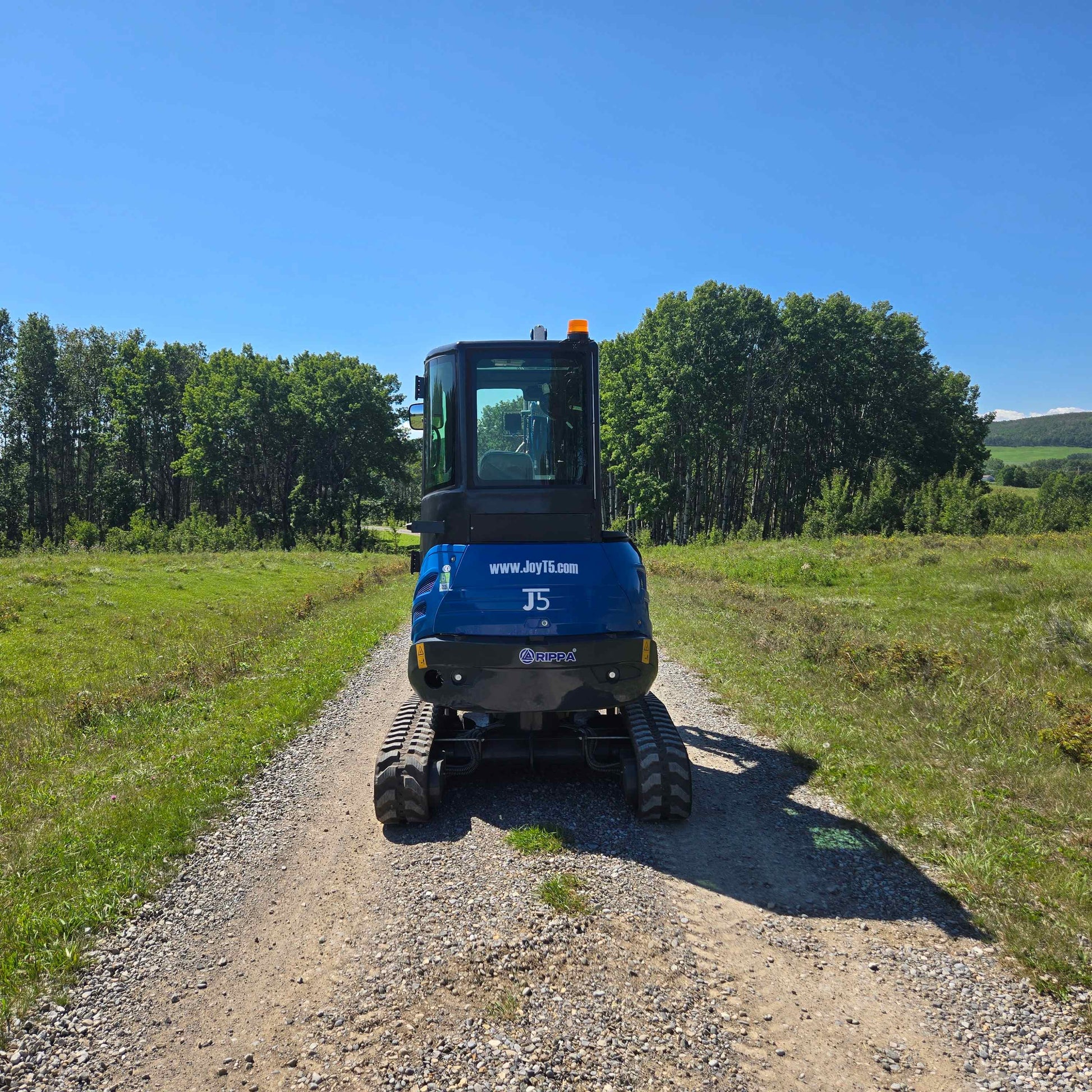 Rippa R22 two ton mini excavator on a countryside gravel road in Canada used for construction and landscaping with JoyT5 dealer support and powerful Yanmar engine