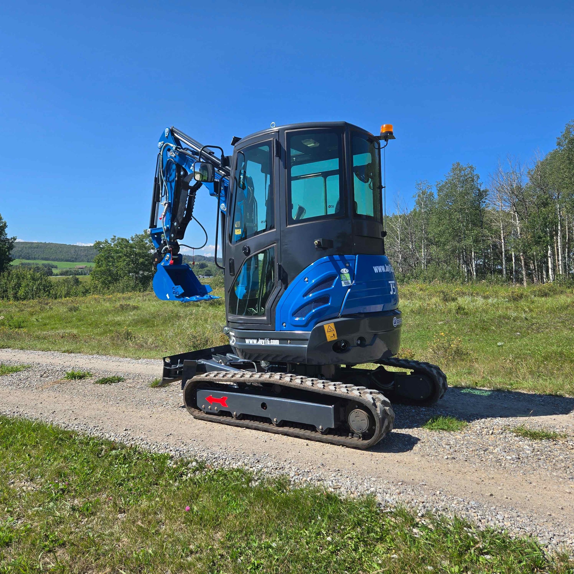 Rippa R22 2 ton mini excavator in Canada from JoyT5 on a gravel path with enclosed cab showing compact construction digger suitable for landscaping and building work