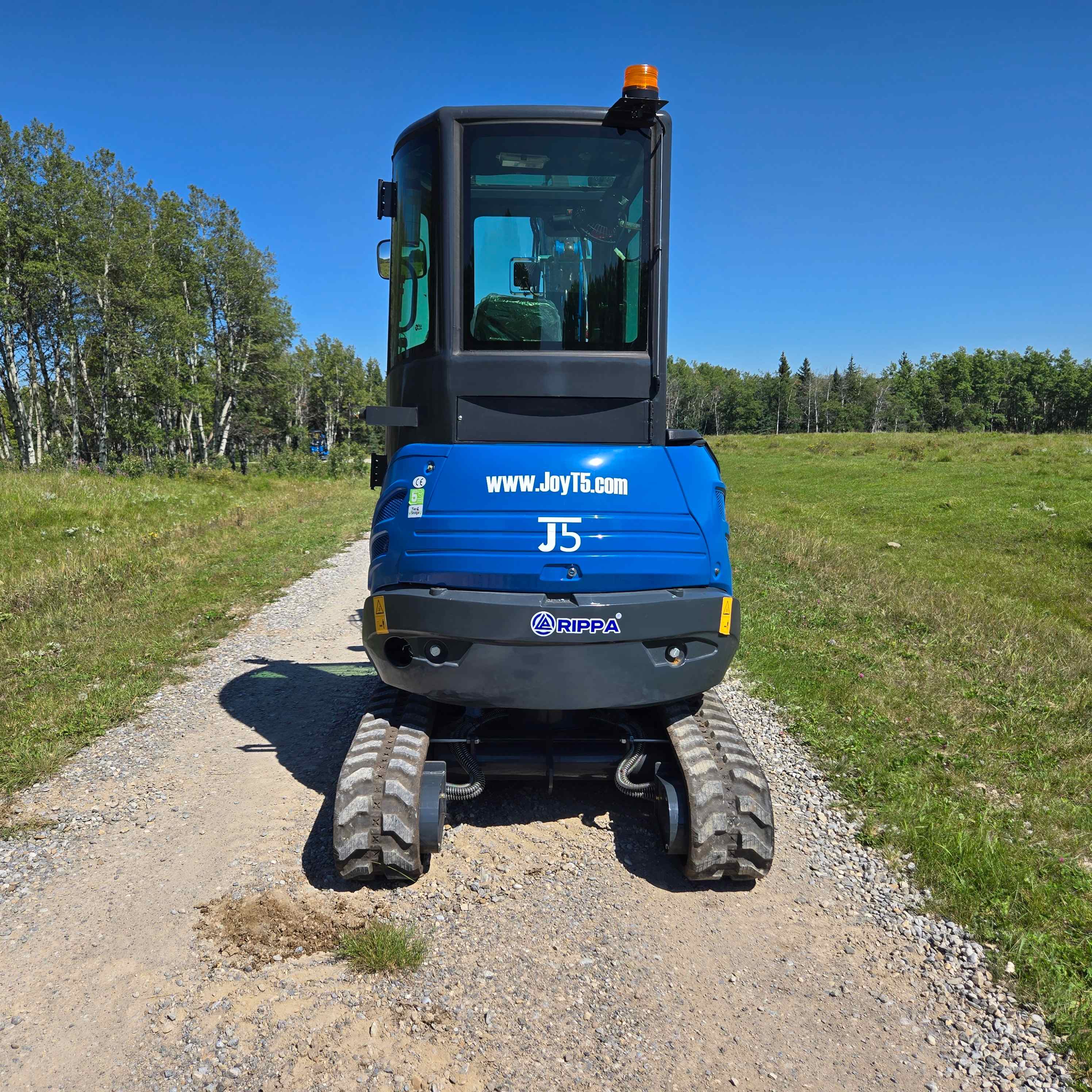 Rear view of Rippa R22 2 ton mini excavator on gravel trail in Canada with JoyT5 compact excavator support for landscaping and construction projects