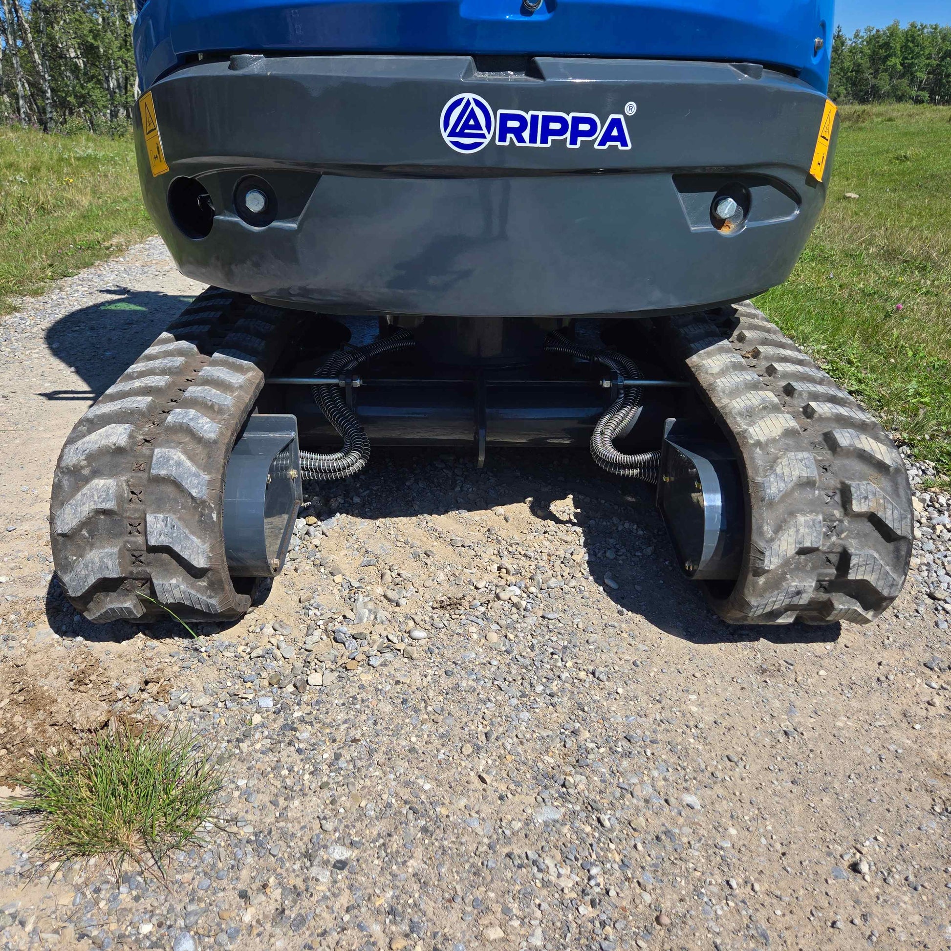 Close view of Rippa R22 2 ton mini excavator rubber tracks and undercarriage working on gravel in Canada with JoyT5 dealer support