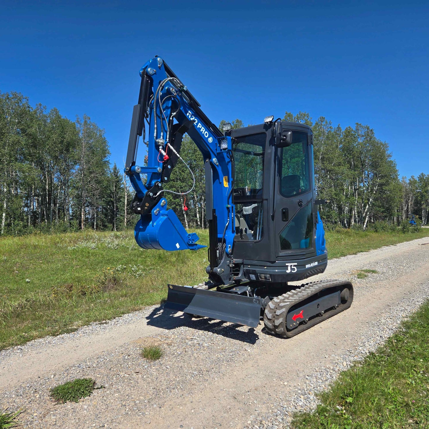 Rippa R22 Mini Excavator angled side view on gravel path compact 2 ton excavator with Yanmar engine for sale in Canada used for construction and landscaping JoyT5