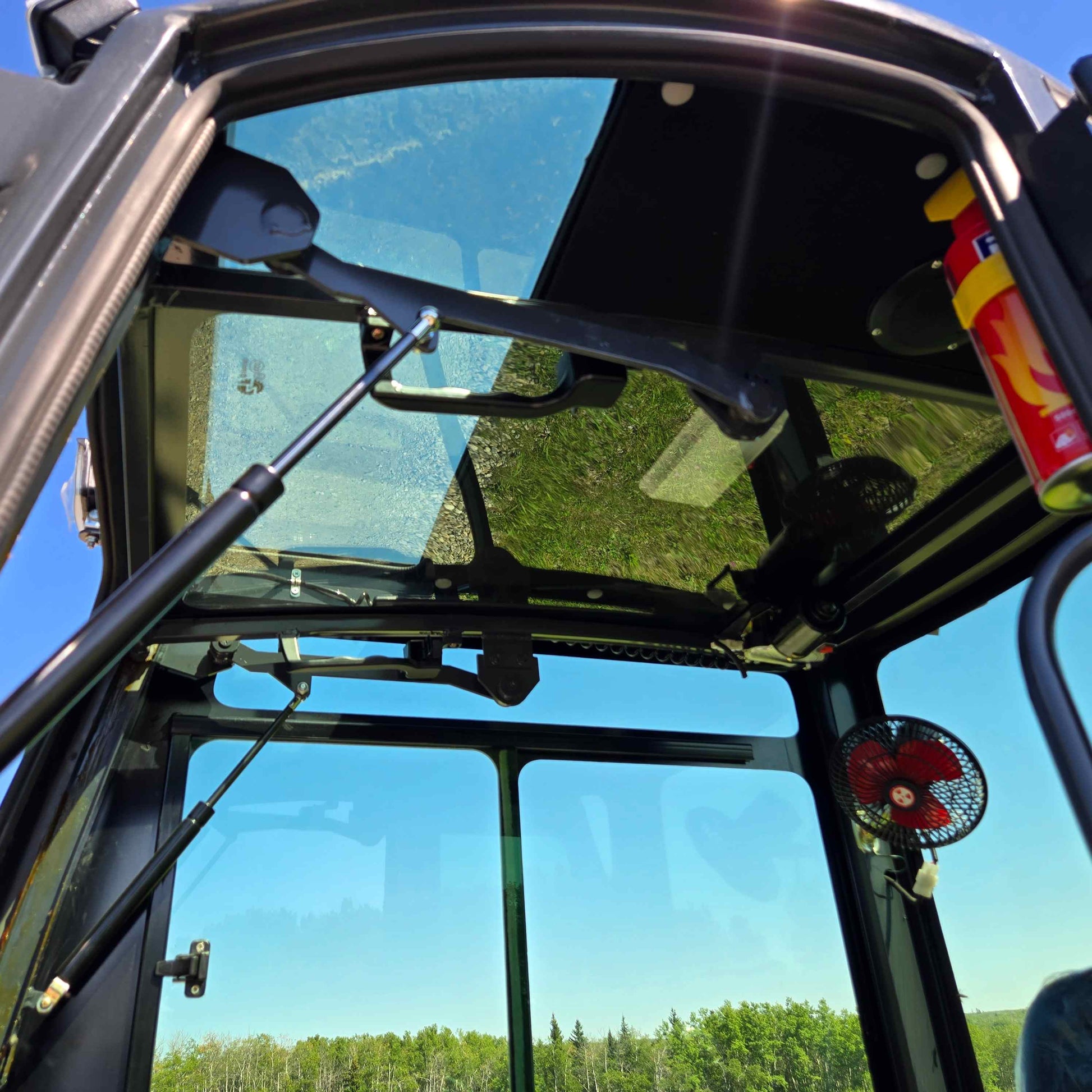 Interior roof view of Rippa R22 mini excavator cabin – compact 2 ton excavator for sale in Canada with Yanmar engine, featuring glass roof, fan, and safety equipment.

