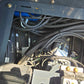 Close-up view of Rippa R22 Mini Excavator for sale hydraulic hoses, electrical wiring, and valve connections inside the machine compartment.
