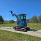 Rippa R22 Mini Excavator for sale rear side view with lifted bucket on gravel road.
