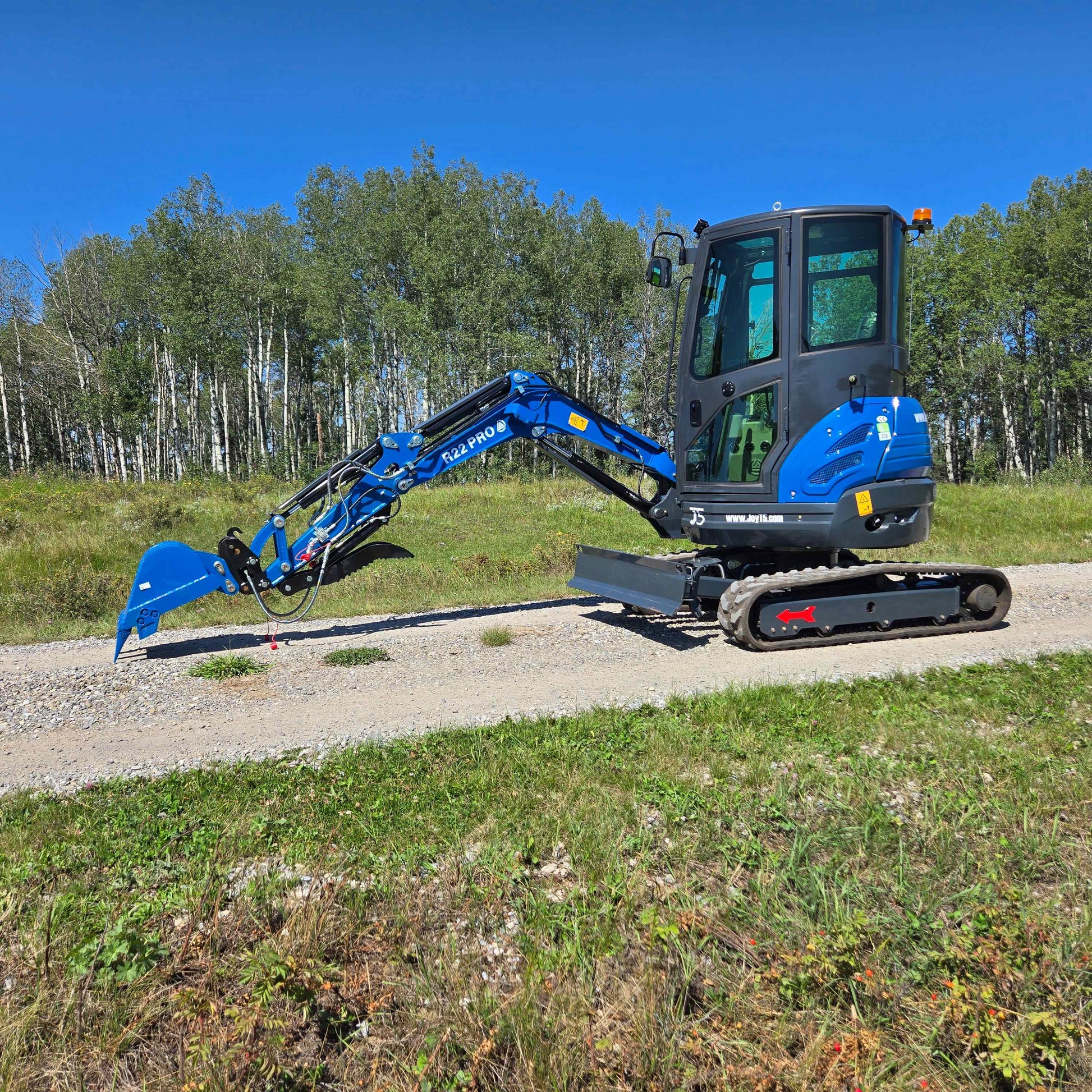 Rippa R22 Mini Excavator for sale side view with extended digging arm on gravel path.
