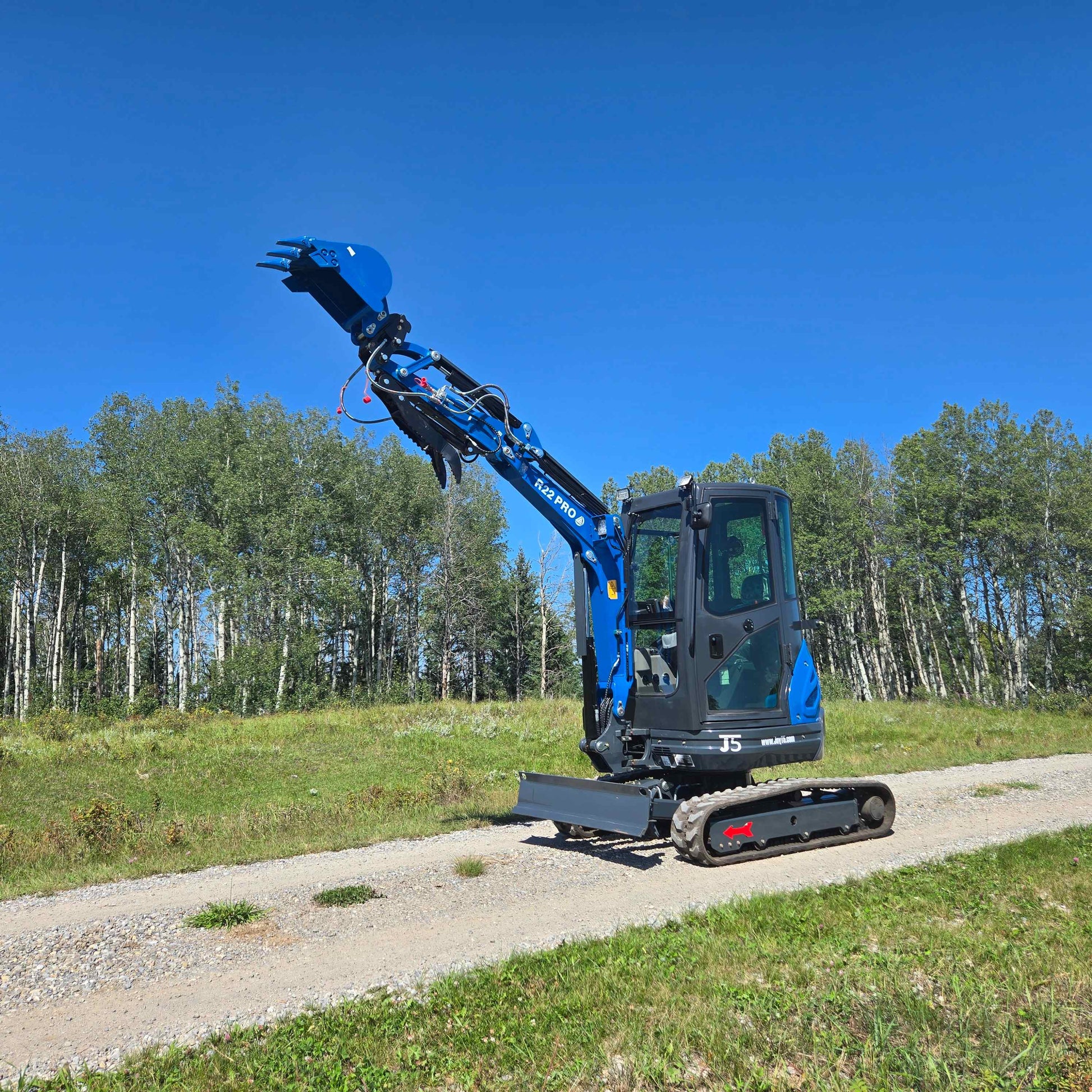Rippa R22 Mini Excavator for sale with extended arm and bucket – Compact excavator on gravel road.
