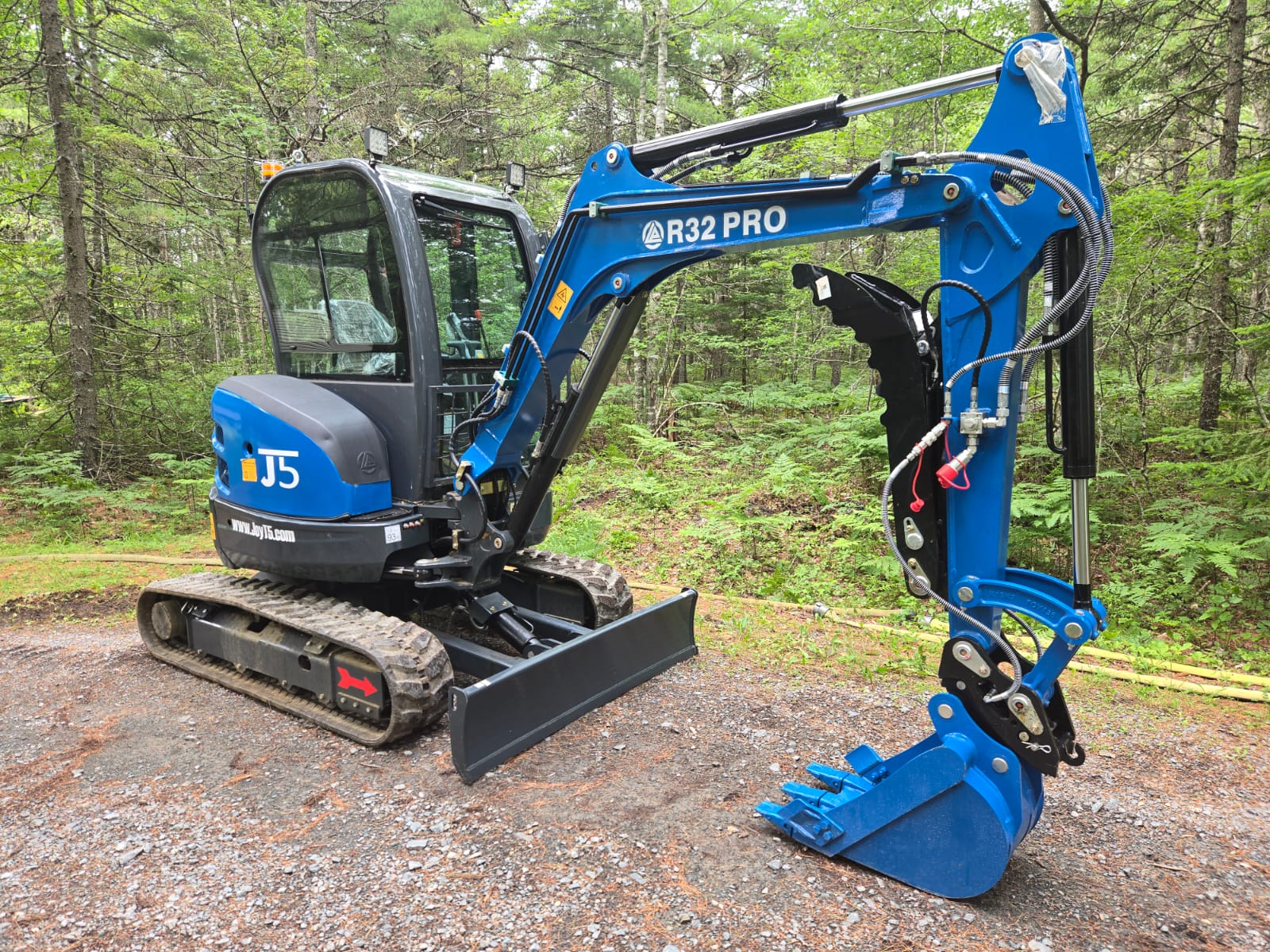 Rippa R32 Mini Excavator with trenching bucket shown in Canada forest, compact excavator for landscaping and construction | JoyT5