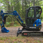 Side view of Rippa R32 Mini Excavator with enclosed cab and hydraulic arm in Canada |  JoyT5