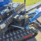 Close-up of rippa r15 mini excavator for sale undercarriage with rubber track, hydraulic arm, and red directional arrow