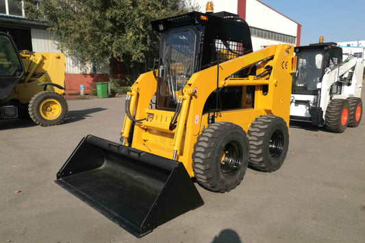 Yellow wheeled skid steer loader parked outdoors in Canada showing compact design and front bucket for construction and farming use

