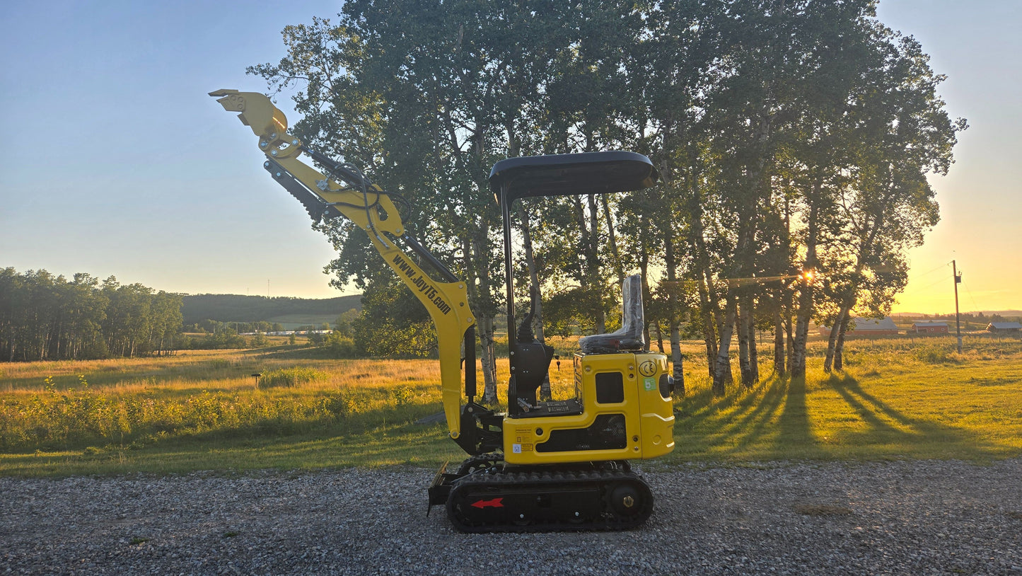 YardHoe YH12 mini excavator with boom arm fully raised on gravel road at sunset.
