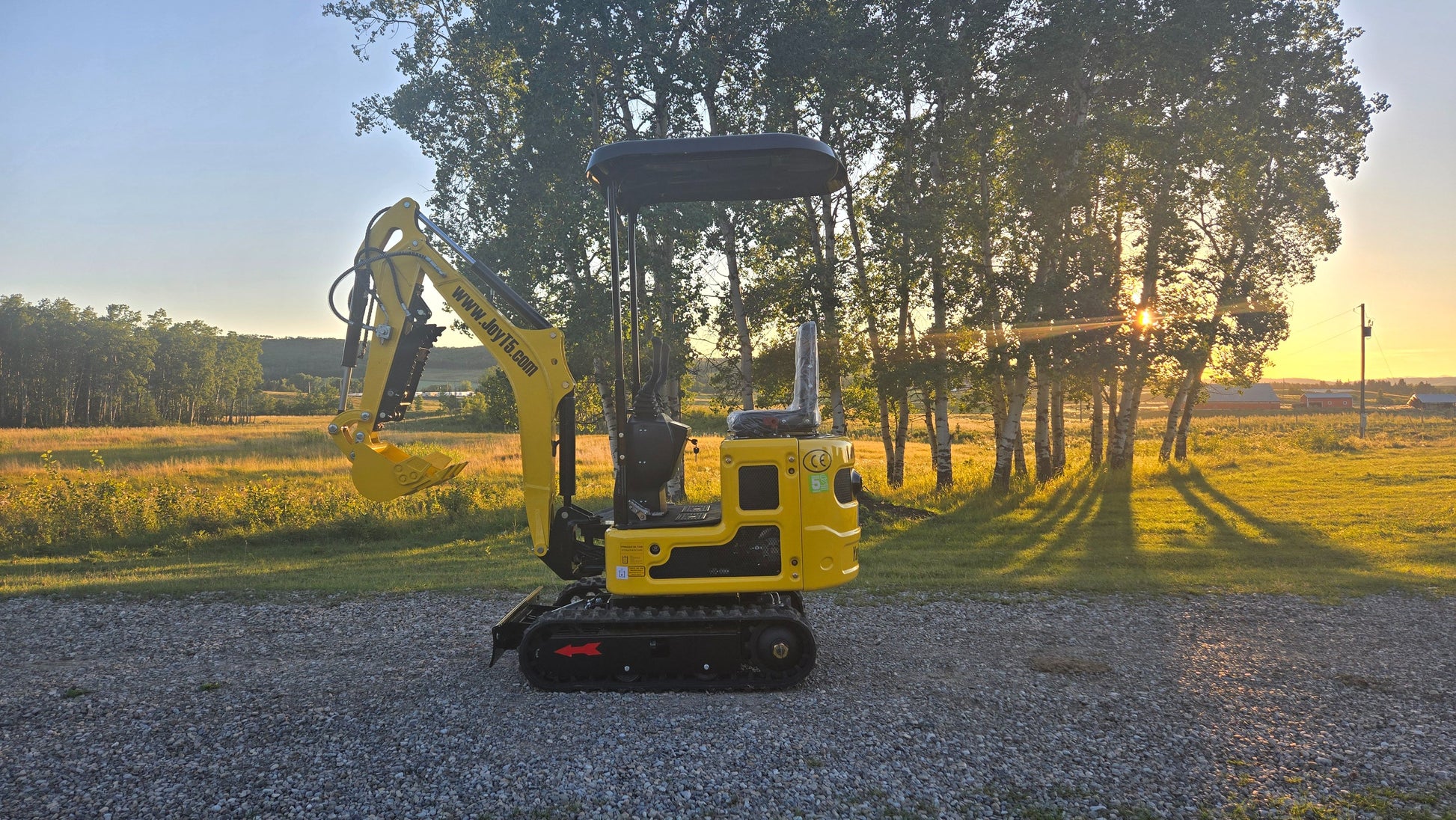 YardHoe YH12 / Rippa R319 1 ton mini excavator for sale side view at sunset, compact digger for small yard and farm projects in Canada and USA.
