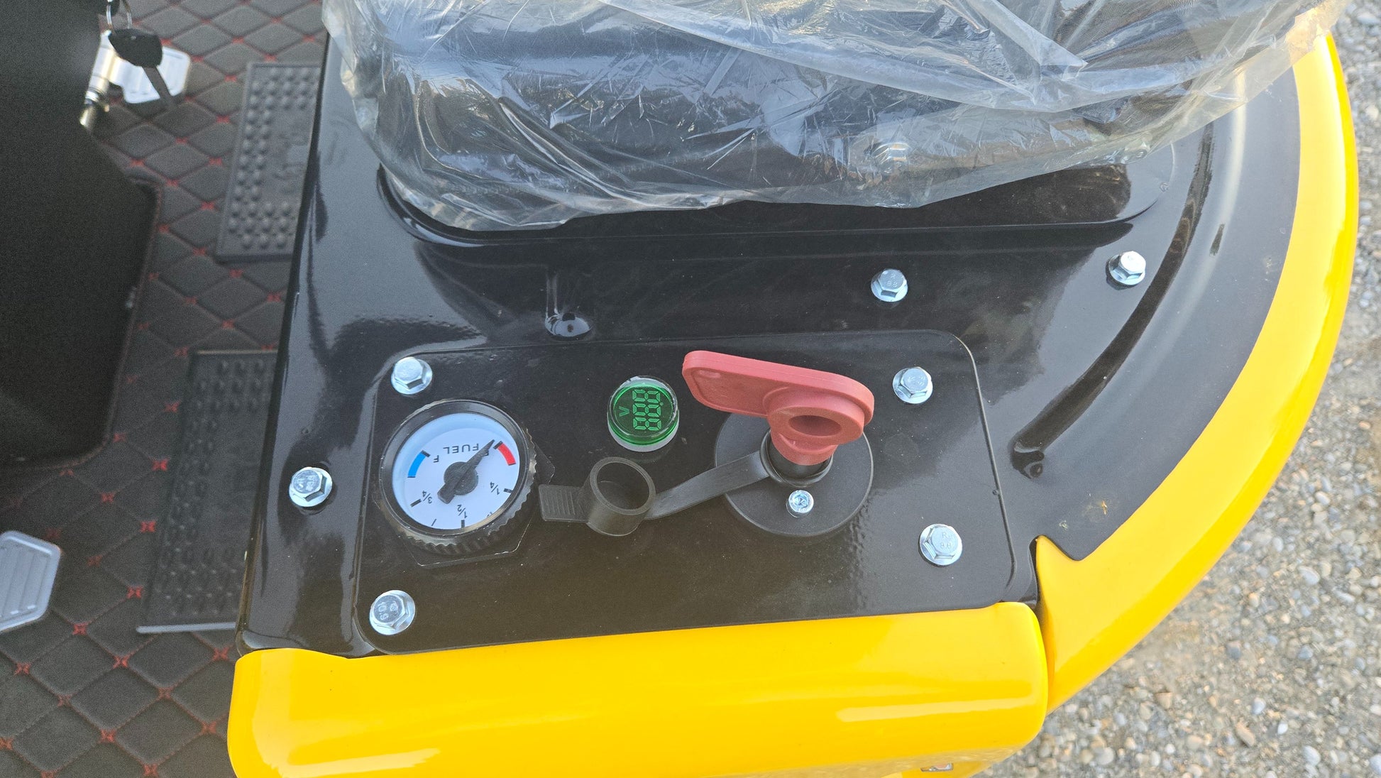 Close-up of YardHoe YH12 / Rippa R319 mini excavator control panel showing fuel gauge, digital display, and safety switch, compact digger Canada USA.
