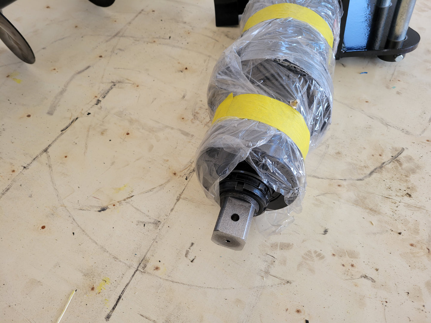 Hydraulic auger for excavators Canada and USA close up view showing wrapped drive motor for excavator auger attachment used in foundation drilling and heavy construction work.

