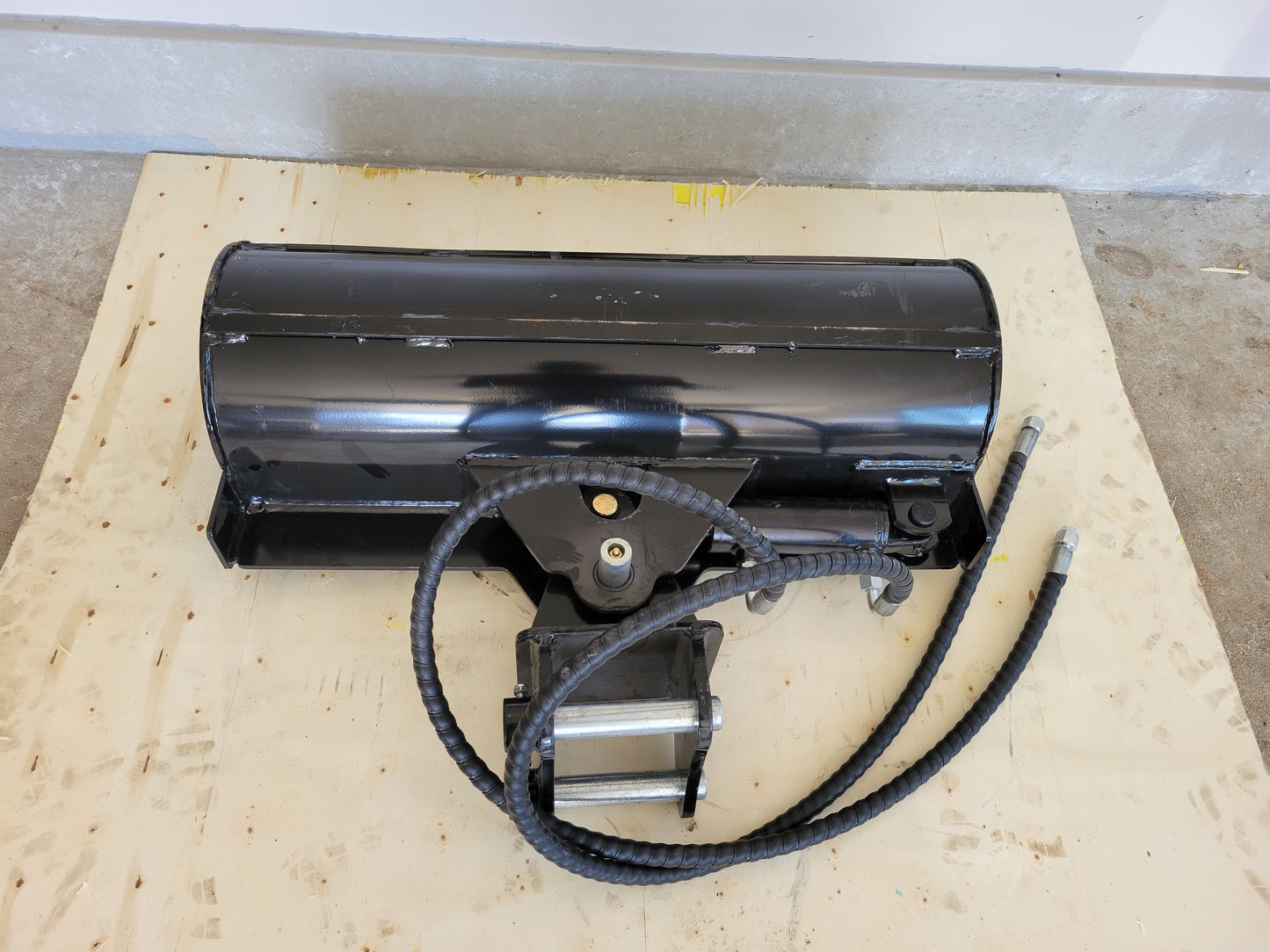 Hydraulic tilt bucket attachment top view showing hose connection and strong steel build for excavator grading and heavy digging in Canada