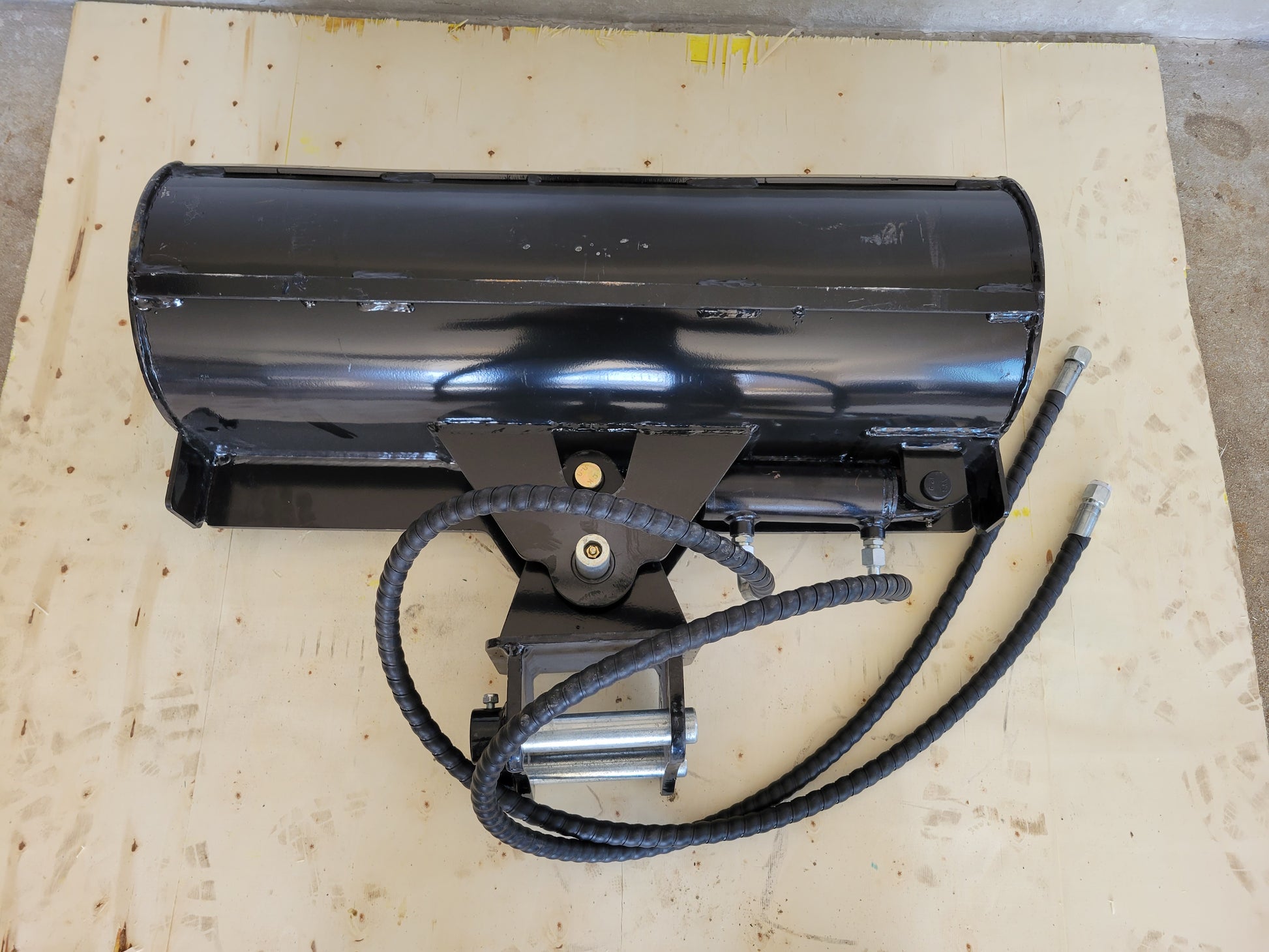 Hydraulic tilt bucket heavy duty attachment top view showing hydraulic hoses and reinforced steel body for excavator digging and grading in Canada

