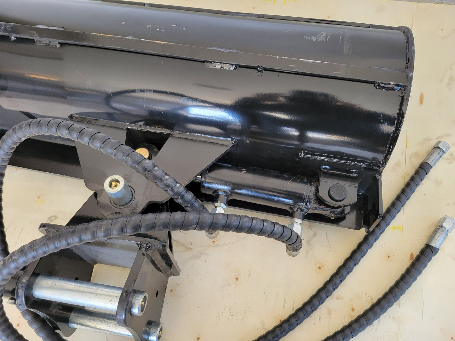 Close up hydraulic tilt bucket showing hose connection and strong cylinder mount for excavator grading digging and heavy duty work in Canada