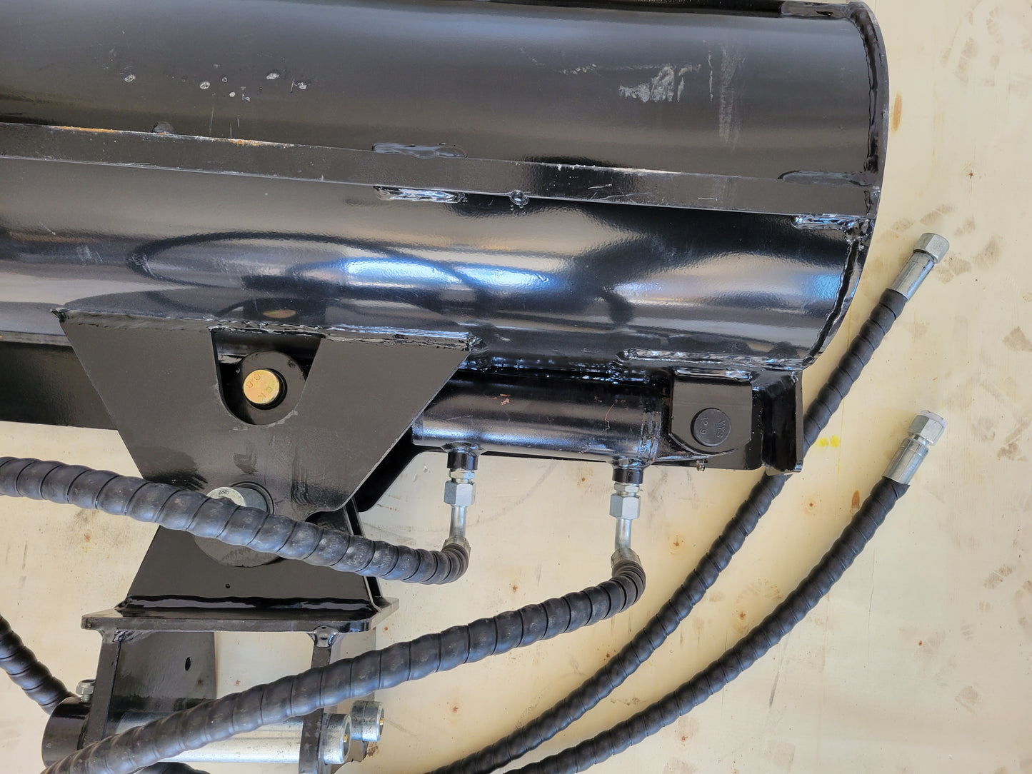 Close up view of hydraulic tilt bucket showing hose fittings and cylinder joint used for mini and heavy excavator grading and digging in Canada

