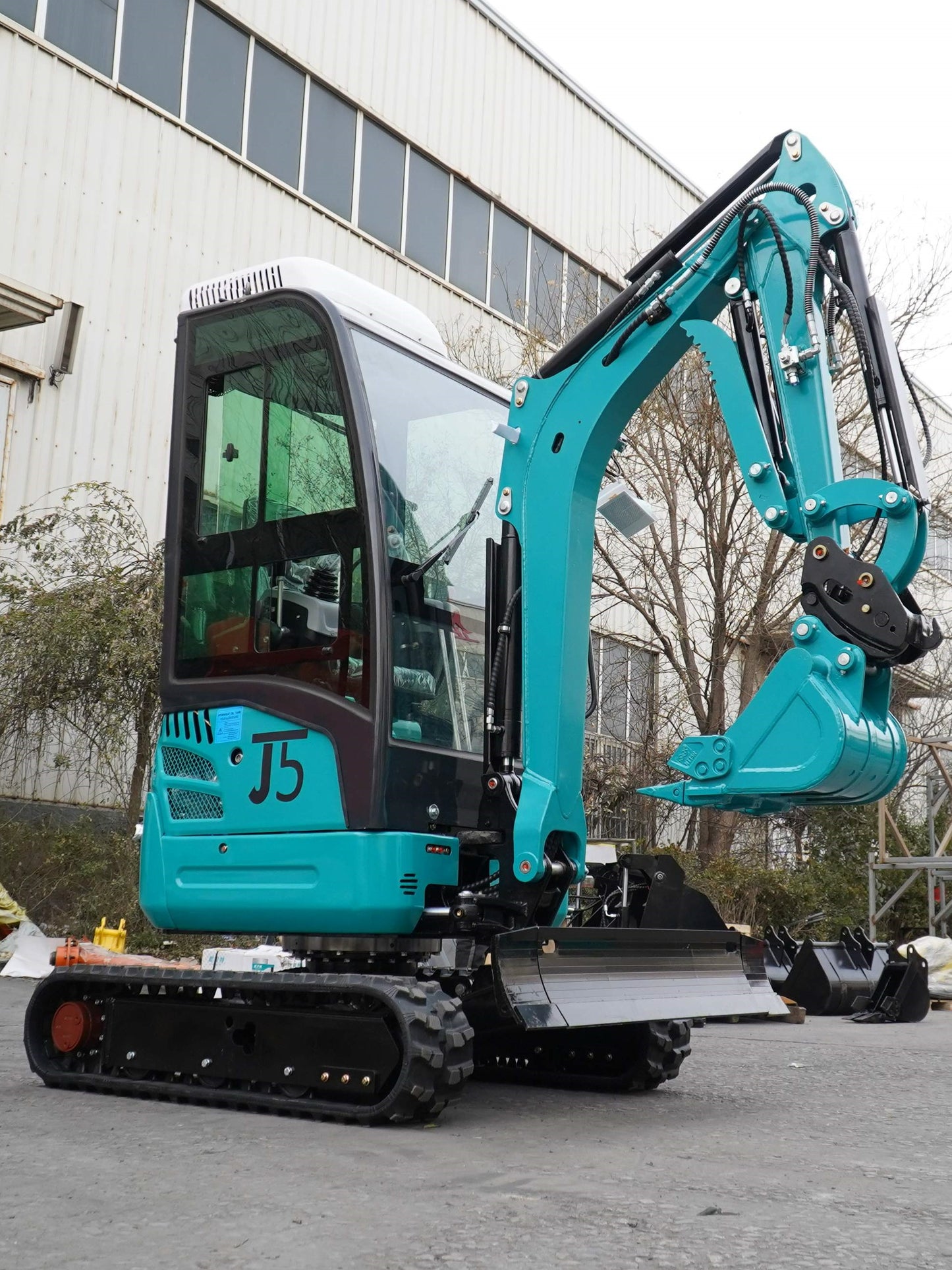 JT5200 Special Edition 2 Ton Mini Excavator side view with hydraulic thumb, side swing boom, and Kubota engine – compact 4400 lbs digger for landscaping, digging, and construction.
