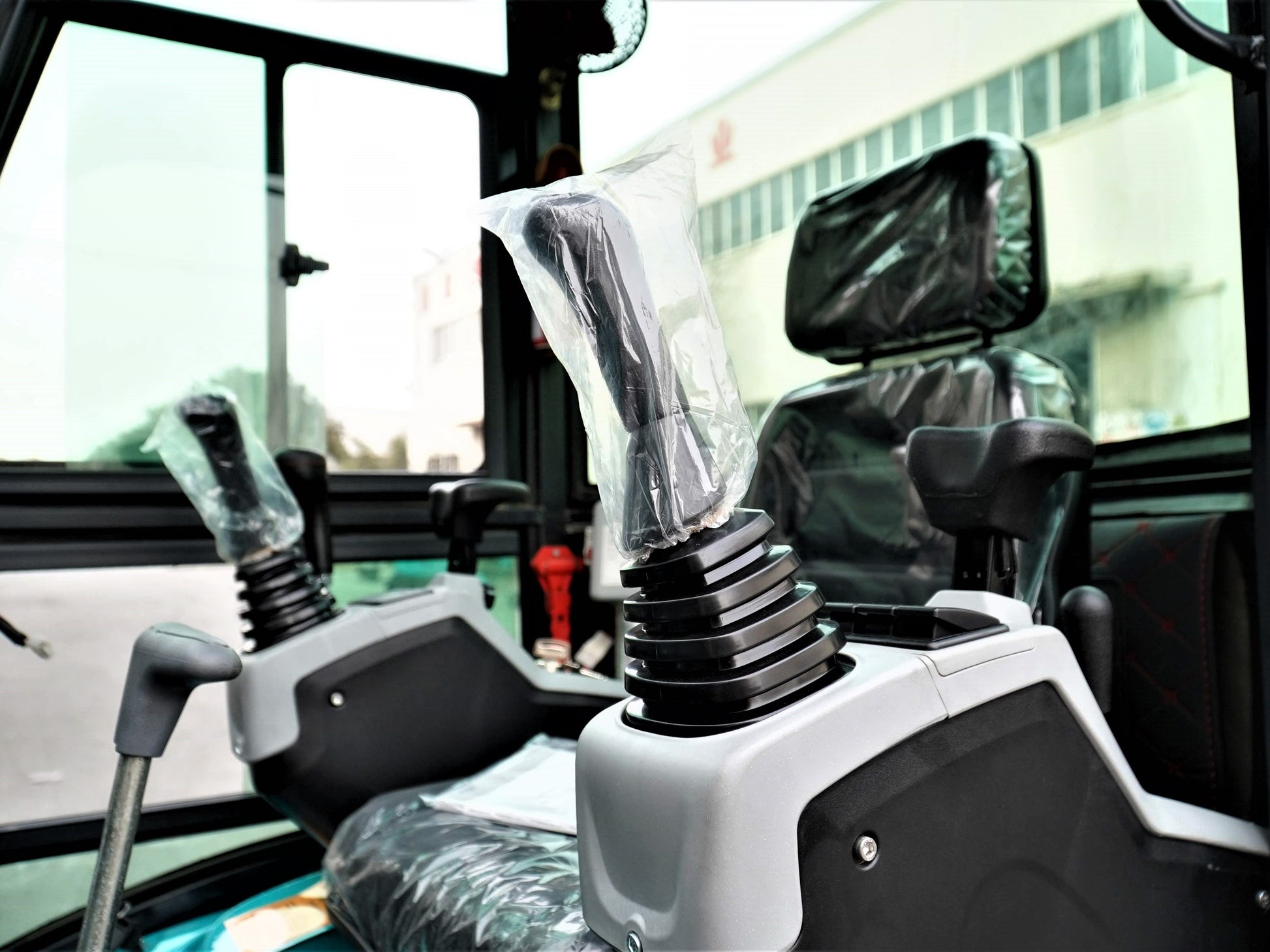 JT5200 2 Ton Mini Excavator cabin interior with comfortable operator seat, dual joystick hydraulic controls, and ergonomic armrests for easy operation.