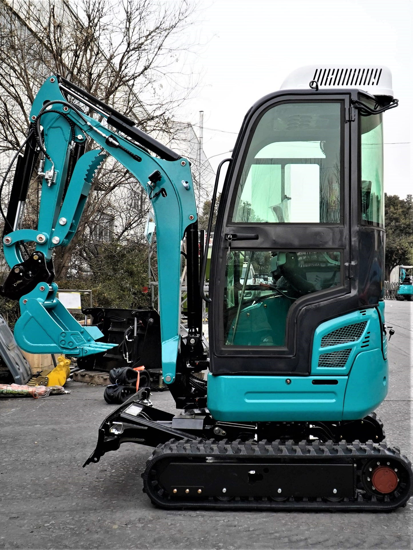 JT5200 Special Edition 2 ton mini excavator side profile in Canada showing full cab u boom zero tail design and rubber tracks for compact construction with JoyT5