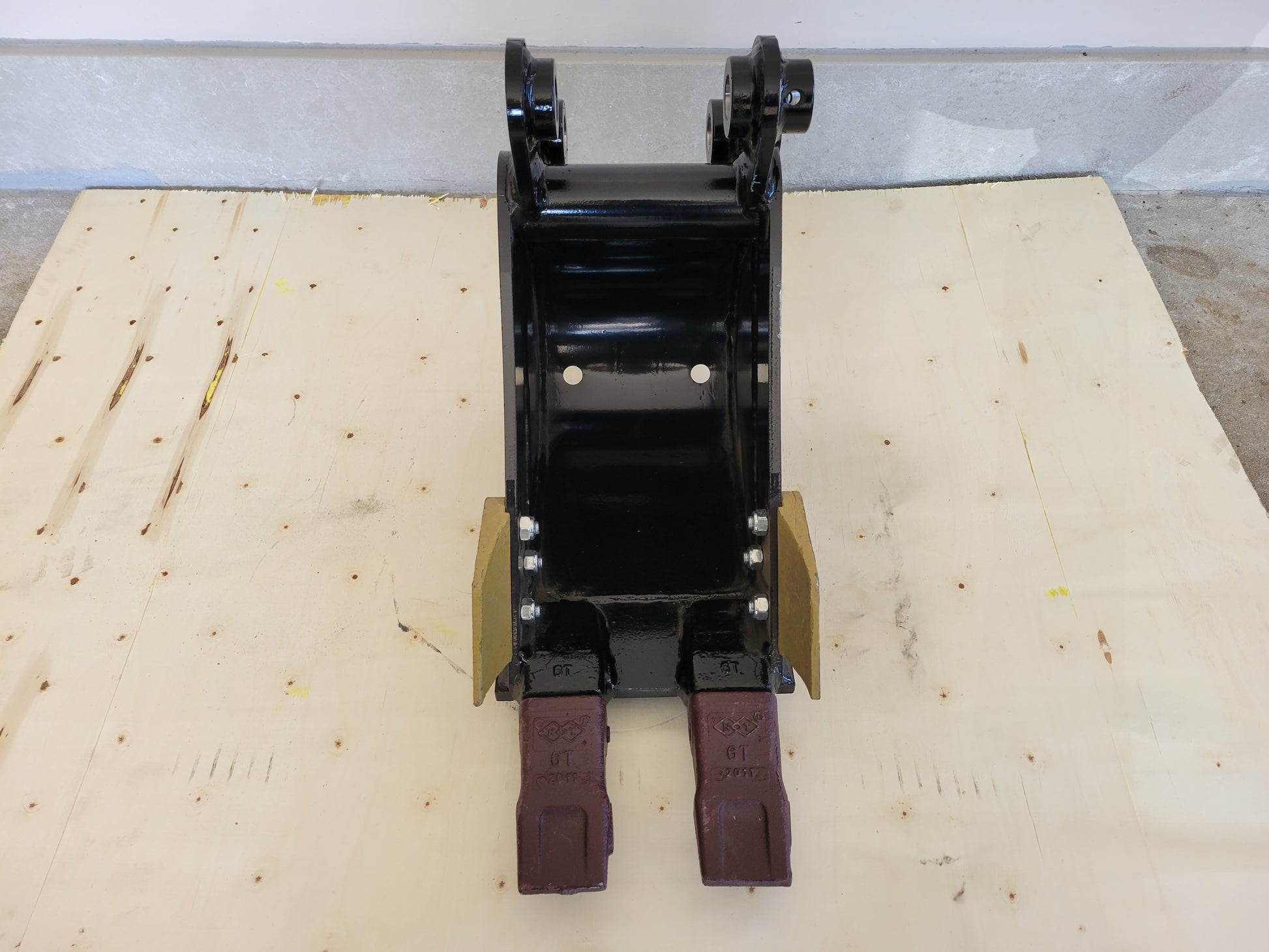 Mini excavator trenching bucket front view showing reinforced steel sides and sharp digging teeth for drainage and construction work in Canada